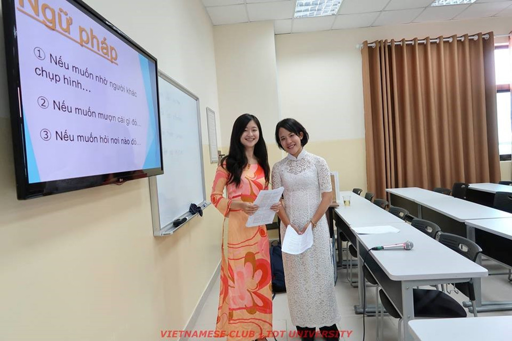 Two beautiful, graceful Japanese female students in Vietnamese ‘Ao dai’